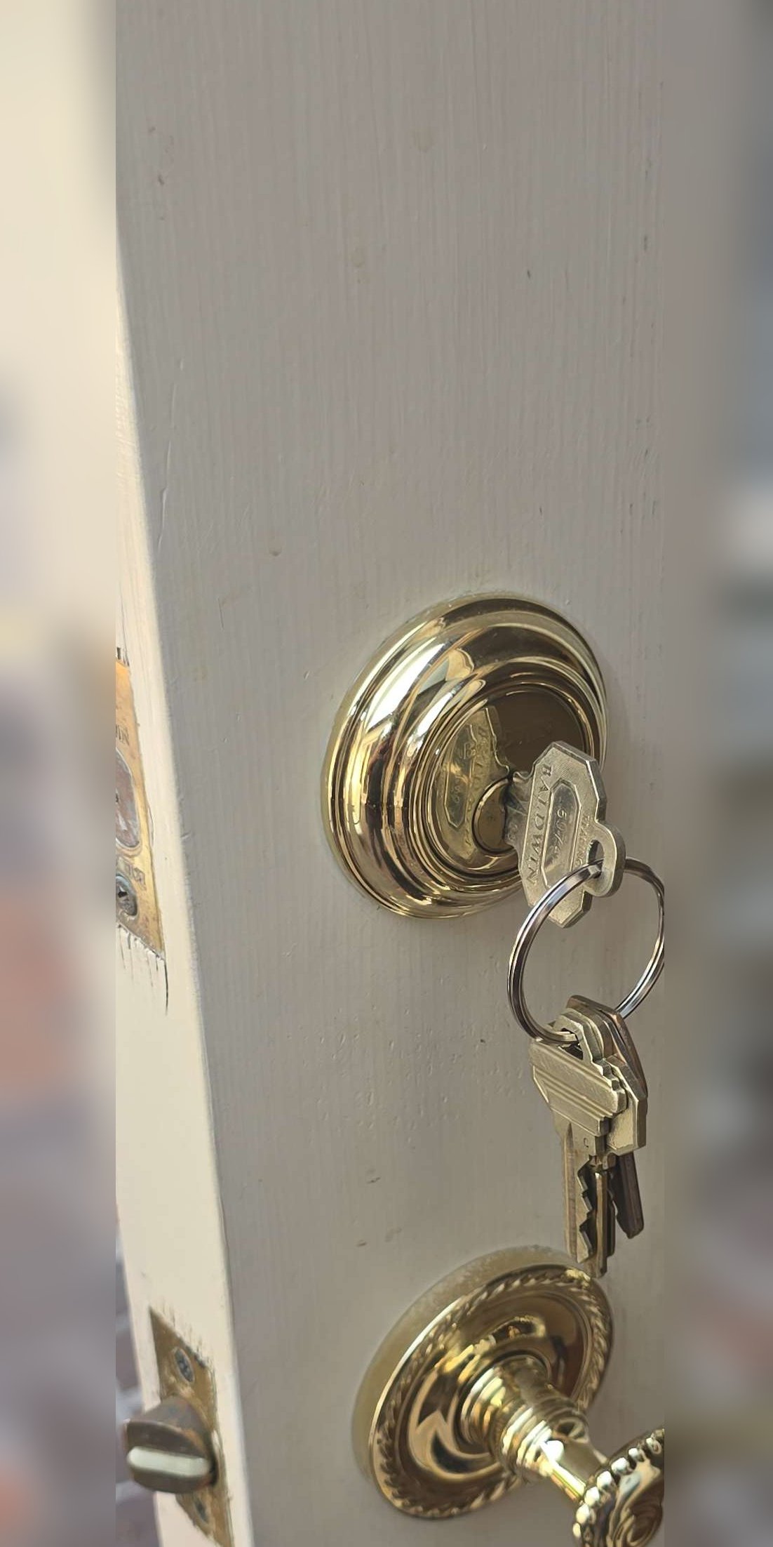 Double-keyed deadbolt with keys hanging from the interior cylinder
