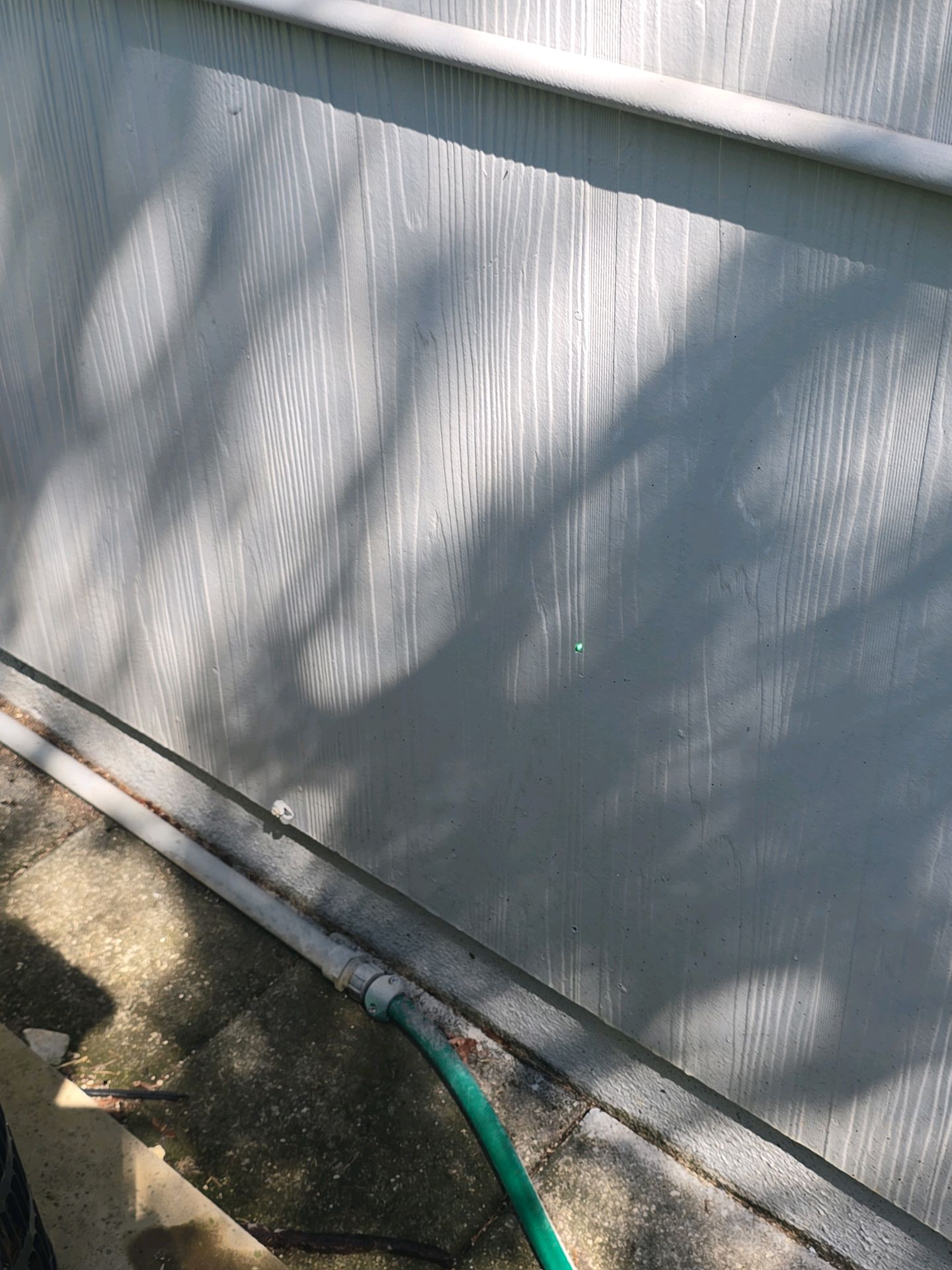 Fiber cement exterior siding with localized overdriven fastener damage